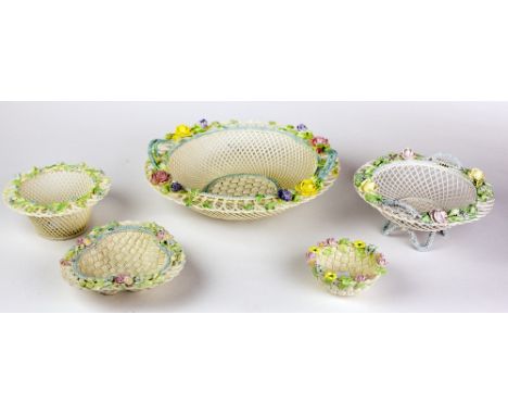 An attractive collection of five varied sized floral encrusted and pierced decorated Belleek Baskets or Bowls, all of similar