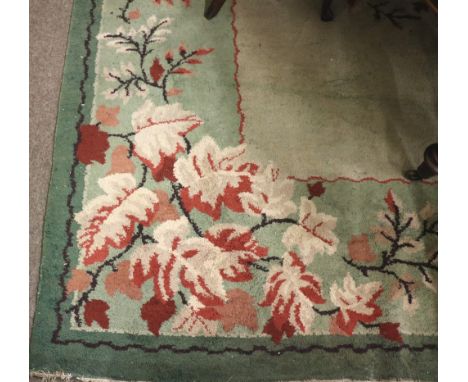 A large green and lime ground Carpet, with floral border decoration and similar central decoration approx. 366cms (12')h x 28