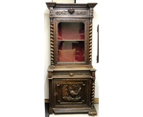 A 19th Century oak Cromwellian style inverted breakfront Display Cabinet, the carved cornice over a glazed door with barley t