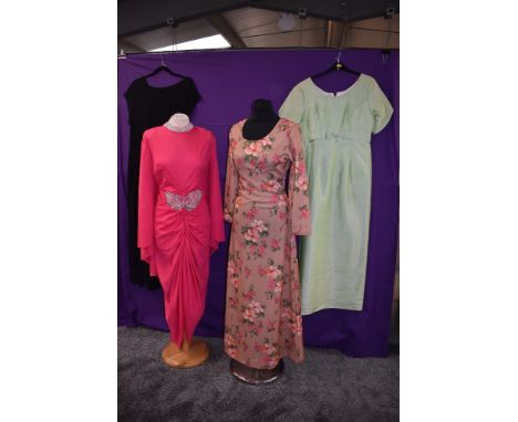 Four vintage dresses, around late 1960s to 1970s including vibrant pink Carnegie dress, and floral maxi dress.