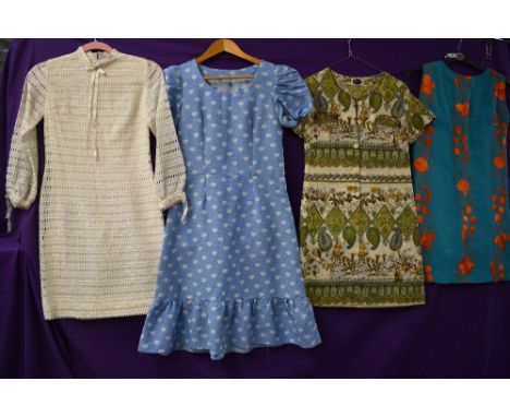 Four vintage dresses having bright patterns in a variety of fabrics and styles,small and medium sizes.