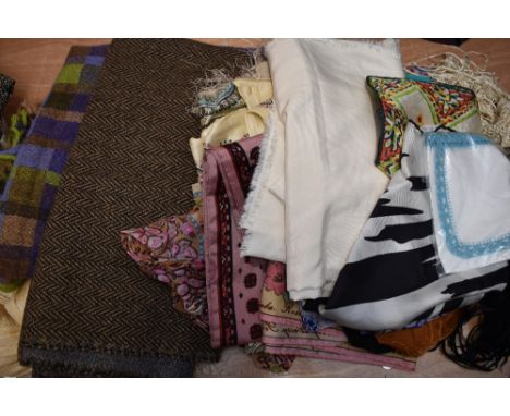 A collection of vintage headscarves and shawls, including Welsh style wool shawl and fringed shawls.