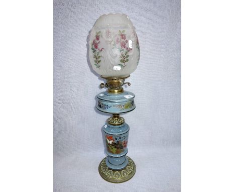 A VICTORIAN BRASS AND GREY GLASS OIL LAMP, the reservoir and column hand painted with flowers, with the original frosted and 