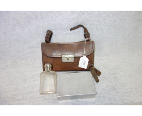 A VINTAGE TRAVELLING LEATHER CANTEEN containing a sandwich box and glass flask