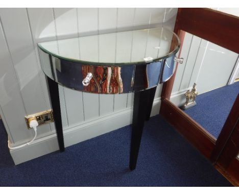 A CONTEMPORARY MIRRORED DEMI-LUNE SIDE TABLE, fitted two drawers with glass knobs on ebonised tapering legs, 76 cm wide