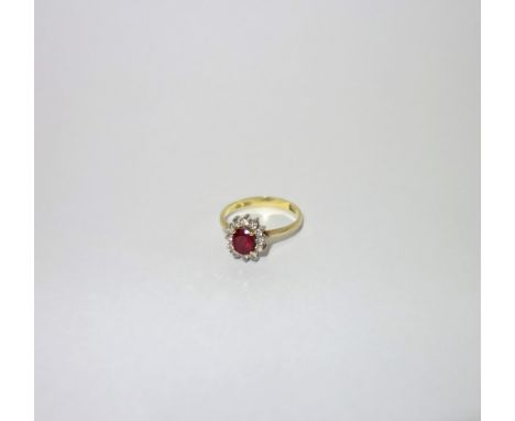 A 'RUBY' AND DIAMOND DRESS RING, on an 18ct yellow gold shank, ring size P