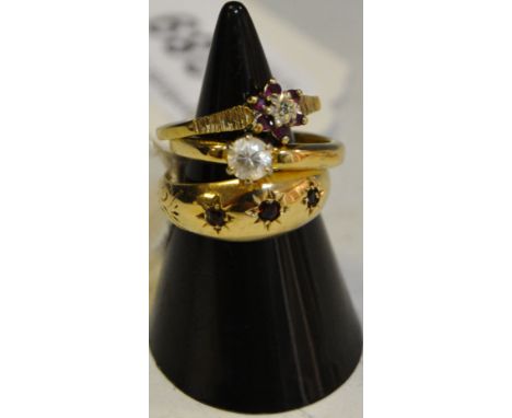 A 9ct gold ring, set with three ruby coloured stones;  two dress rings (3)