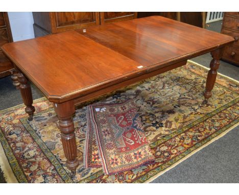 A Victorian mahogany windout dining table, rectangular top, canted angles, moulded edge, turned and reeded legs, ceramic cast