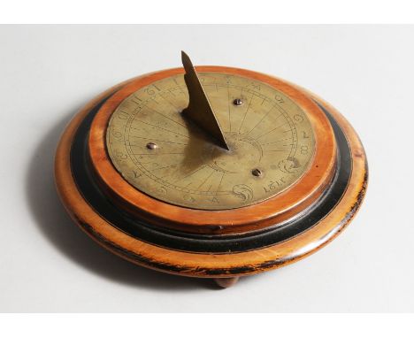 AN EARLY BRASS CIRCULAR SUNDIAL DATED 1727. 5ins diameter.