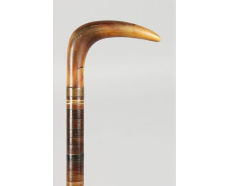 A GOOD RHINO HANDLED SEGMENTED WALKING STICK. 34ins long.