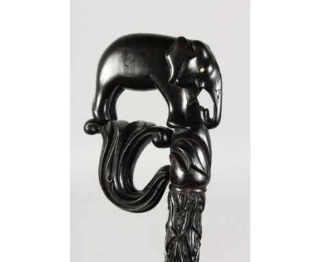 A CEYLONESE CARVED WALKING STICK with elephant handle. 35ins long.