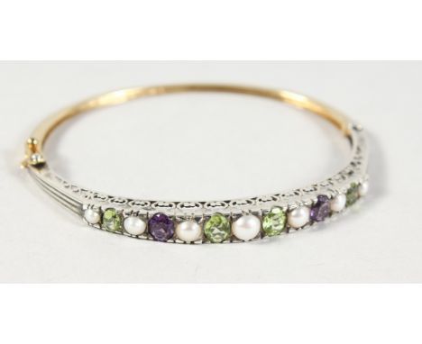A GOOD 9CT GOLD AND SILVER, PERIDOT, PEARL AND AMETHYST BANGLE.