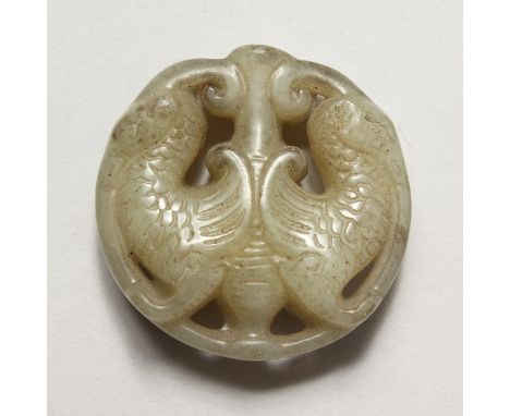 A CHINESE CARVED JADE ROUNDEL. 1.75ins diameter.