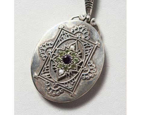 A SILVER, PERIDOT, PEARL AND AMETHYST SUFFRAGETTE STYLE LOCKET.