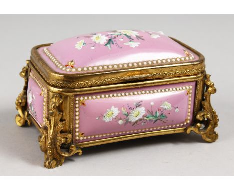 A GOOD CONTINENTAL PINK ENAMEL JEWELLERY BOX, with gilt mounts painted with flowers. 4.5ins long.