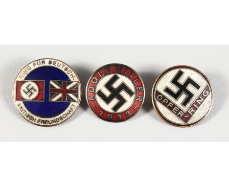 THREE CIRCULAR ENAMEL BADGES OF SWASTIKAS.