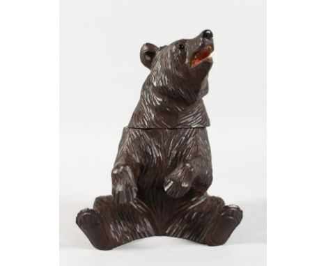 A BLACK FOREST CARVED WOOD BEAR CADDY. 8ins high.