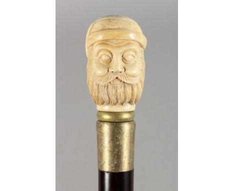 A WALKING STICK, the bone handle carved as a bust of a man. 35.5ins long.