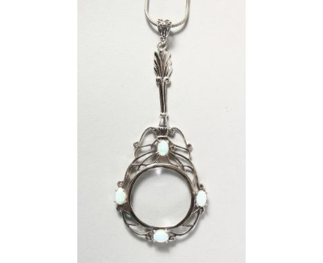 A SILVER AND OPAL SPY GLASS on a chain.