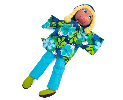 A Pelham Ventriloquial puppet. The female puppet having a painted wooden head and wire operated mouth, blonde hair and wearin