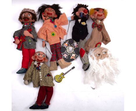 A collection of wooden ventriloquist puppets. In the Pelham puppet style having painted faces and wire operated mouths, inclu