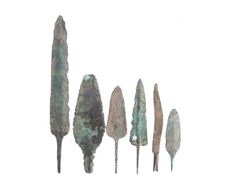 A group of five Bronze Age arrowheads and a Bronze Age razor.(6)