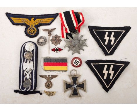 A mixed collection of WWII and later German badges. Comprising cloth and metal examples noting a German Defence medal and tie