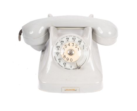 A Vintage rotary dial telephone, in light grey, with coveted lead, 24cm wide.