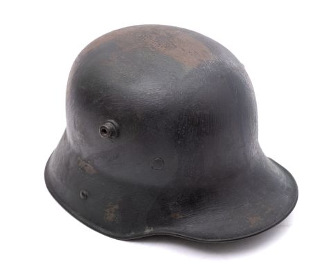 A WWI period German M1916 Stahlhelm, hand painted camouflage finish with white leather liner, the helmet stencilled '64' to i