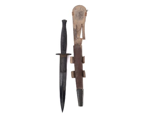 A Wilkinson Sword Fairburn Sykes third pattern fighting knife. Post WWII having a ribbed metal handle and steel blade with in