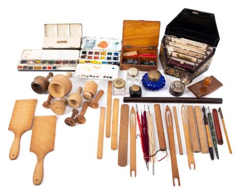 A collection of artists supplies. Comprising three pallets containing oil paints, a range of glass inkwells, stamps and seals