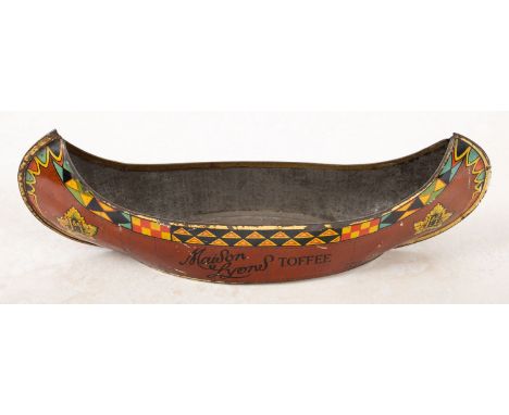 J Lyons & Co Ltd. An early 20th century 'Maison Lyons Toffee' tin, circa 1922, in the shape of a canoe, inscribed as per titl