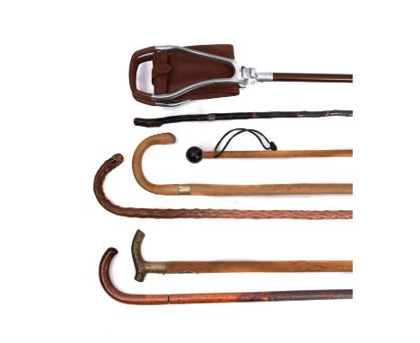 A Gamebird brown leather shooting stick, together with a group of five various walking sticks. (6) 