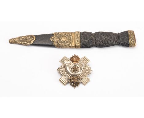 An early 20th century Sgian Dubh, the short blade with rope knot bog oak grip and plated mounts with citrine inset pommel, 18