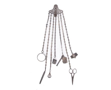A late 19th century steel chatelaine, with  pierced suspension and seven suspension chains with scissors,  penknife, miniatur