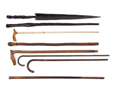 Two early 20th century silver mounted walking sticks, together with a fish vertebrae walking stick and five various other wal