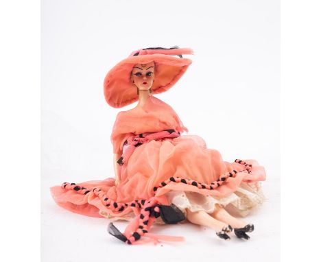A Hong Kong 'Lili' clone doll, circa 1950s, in pink cotton hat and matching dress. together with a later Sindy doll and a sma