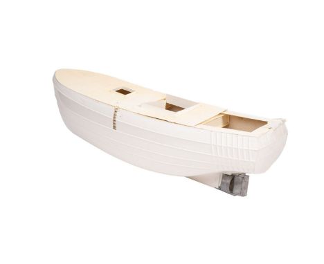 An incomplete scale model of a fishing trawler. The hull and deck of fibreglass with running gear and rudder fitted.