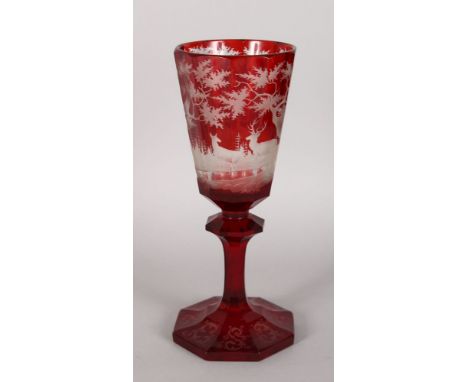 A GOOD LARGE 19TH CENTURY BOHEMIAN GOBLET, ruby etched with a continuous scene of deer in a landscape. 11ins high.