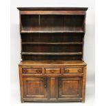 A GOOD EARLY 18TH CENTURY OAK WELSH DRESSER, the Delft rack top with three shelves, on a dresser