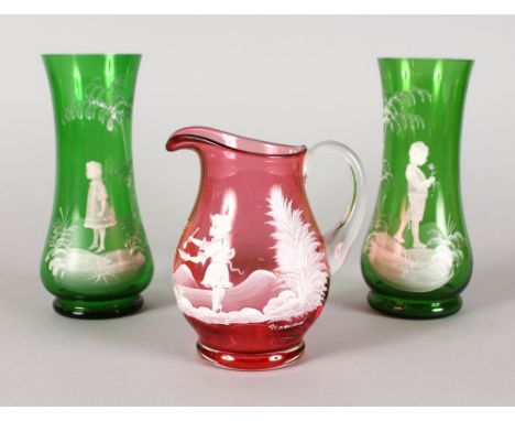 A SMALL PAIR OF MARY GREGORY GREEN VASES, decorated with a boy and girl in white, 7ins high, and A RUBY JUG, 5ins high (2).