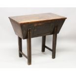 AN 18TH CENTURY OAK DOUGH BIN, with plain top, panel doors in the side, on tapering legs. 2ft
