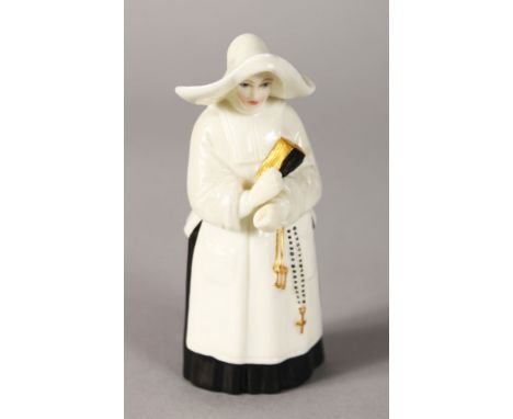 A ROYAL WORCESTER CANDLE SNUFFER "THE NUN". 3.5ins high.