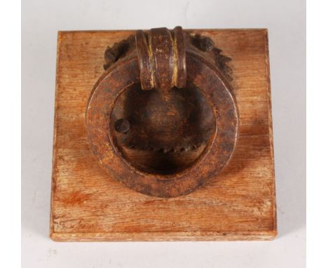 A VERY HEAVY CAST IRON RING KNOCKER. 5ins diameter.