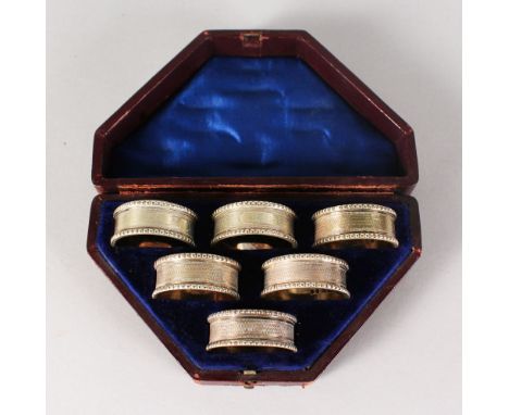 A GOOD SET OF SIX VICTORIAN ENGINE TURNED SERVIETTE RINGS, Numbered 1-6, in a fitted case.
