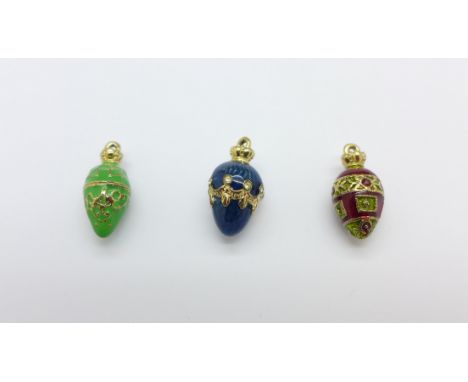 Three enamel egg pendants