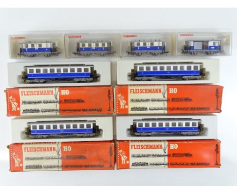 A group of HO Gauge European Outline 4 wheel and bogie coaches by FLEISCHMANN in the fictitious Edelweissbahn blue/white live