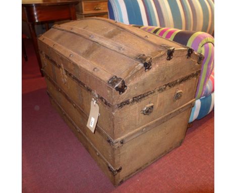 A 19th century dome top travel trunk with wooden binding and faux crocodile metal clad finish. 