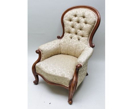 A 19TH CENTURY MAHOGANY SHOW WOOD FRAMED BUTTON BACKED ARMCHAIR with all over old gold upholstery, serpentine fronted seat pa