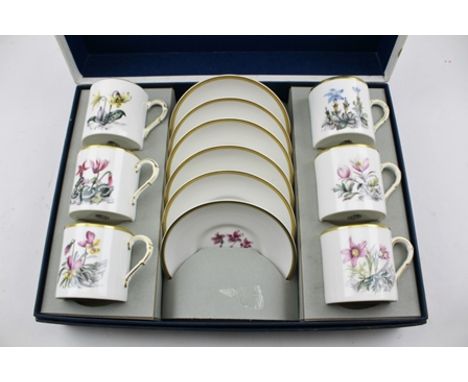 A ROYAL WORCESTER COFFEE SET circa 1970, in the original presentation box, polychrome decorated with flora on a white ground 